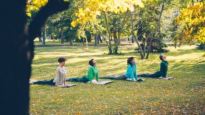 Peaceful outdoor yoga class focusing on back pain relief
