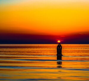 Woman meditating at sunset in Bali