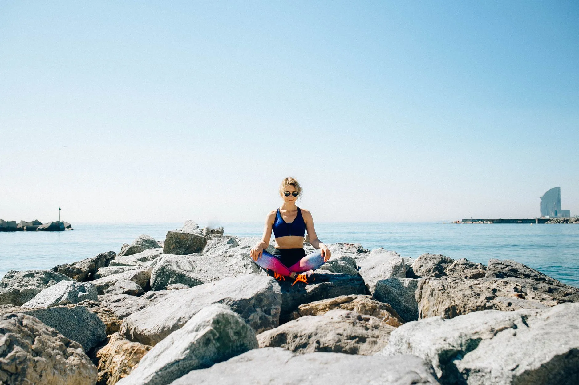 Individuals meditating by a peaceful beach