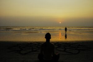 Beautiful sunset yoga by the beach in Bali